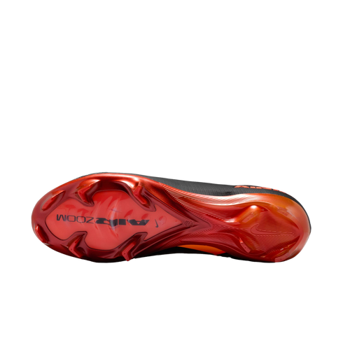 Bottom view of a Nike Air Zoom Mercurial football boot soleplate, featuring metallic red and orange colors with black accents and triangular studs on a black background.
