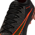 Close-up of a black Nike soccer boot featuring textured Gripknit, black laces, and a vibrant orange swoosh with an iridescent center.