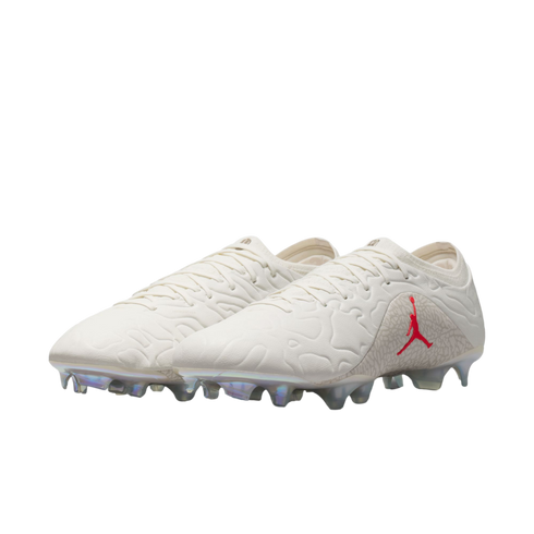 A pair of off-white Jordan Brand soccer cleats featuring a red Jumpman logo, elephant print accents, and iridescent studs against a white background.