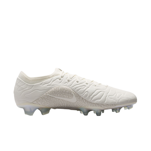 An off-white Nike soccer cleat with a textured upper and clear studs, shown from a side profile against a white background.