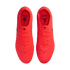 Top-down view of vibrant neon orange Nike and Jordan soccer cleats on a black background, with "TRANSCEND THE GAME" text on the insoles.
