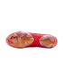 Bottom view of a red Nike Tiempo soccer cleat showing its iridescent soleplate, golden Nike swoosh, and stud pattern against a black background.