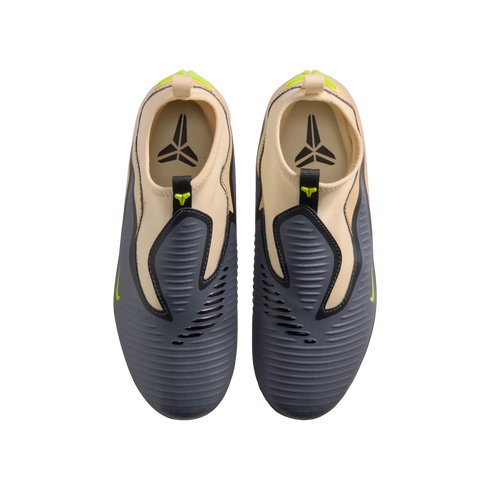 A top-down shot of grey and tan Nike Kobe slip-on sneakers with lime green details and the Kobe logo on the insoles, displayed against a black background.
