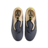 A top-down shot of grey and tan Nike Kobe slip-on sneakers with lime green details and the Kobe logo on the insoles, displayed against a black background.
