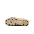 Underside of a beige Nike soccer cleat featuring black studs and a small neon green swoosh on the heel against a black background.