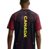 Back view of a person wearing a black jersey with "CANADA" in vertical yellow text down the center, featuring intricate red line patterns on the shoulders and back.