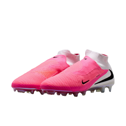 A pair of vibrant pink and white Nike soccer cleats with black swoosh logos and iridescent soleplates, set against a plain white background.