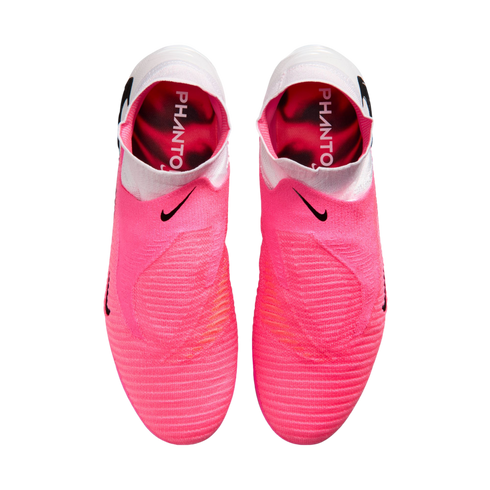 Top-down view of pink Nike Phantom soccer boots with white collars and black swooshes. The pink insoles feature the word "PHANTO" in white text.