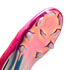 Close-up of an iridescent pink and gold Nike soccer cleat sole with clear studs and "NIKE CYCLONE 360" text.
