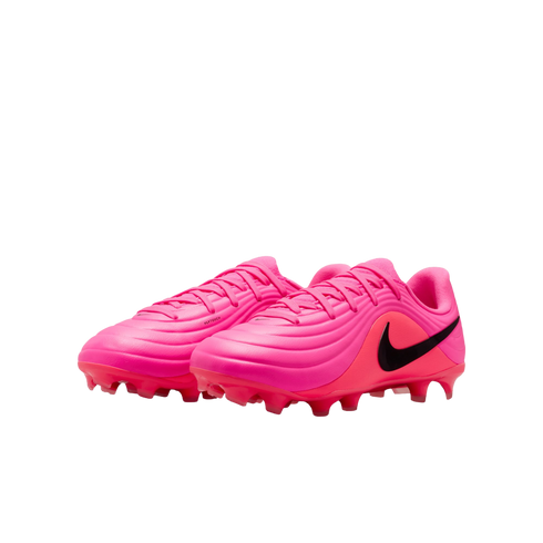 A pair of bright pink Nike soccer cleats with black swooshes and textured uppers on a white background.