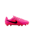 Vibrant pink Nike soccer cleat with a black swoosh, featuring a ridged textured upper and studs on the sole, set against a plain white background.