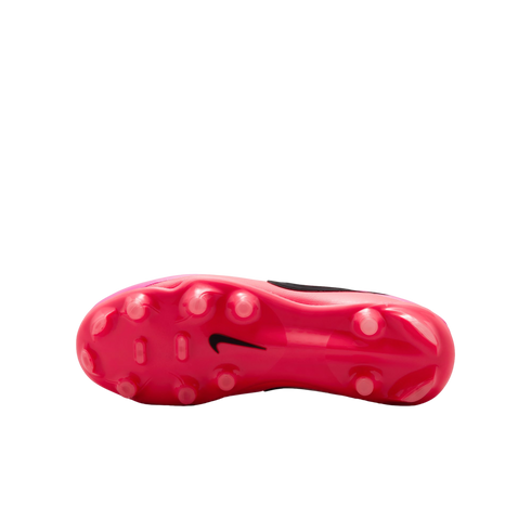 Bottom view of a pink Nike soccer cleat, featuring several rounded studs and a black Nike swoosh logo in the center.