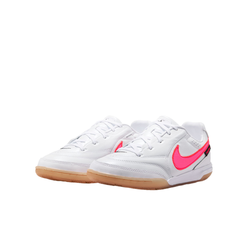 White Nike indoor soccer shoes with a neon pink swoosh and gum rubber soles.