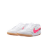 White Nike indoor soccer shoes with a neon pink swoosh and gum rubber soles.
