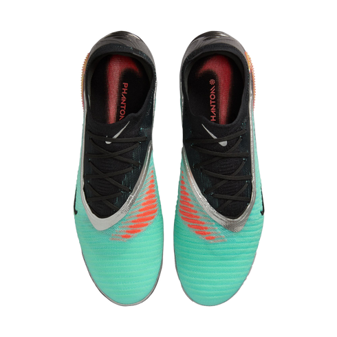 Top-down view of a pair of Nike Phantom soccer boots in turquoise and black with silver accents and orange striped details.
