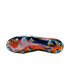 Bottom view of a Nike soccer cleat with an iridescent, multi-colored metallic sole plate and traction studs, set against a plain white background.