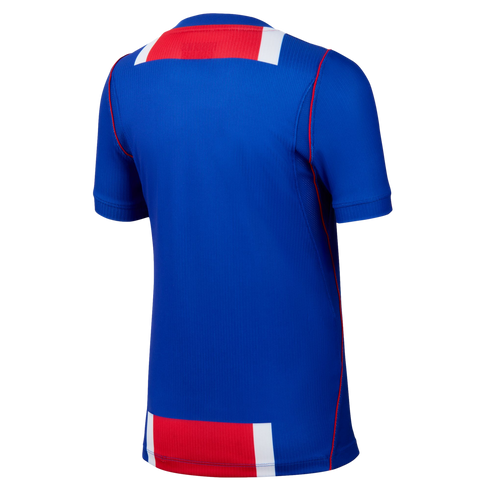 Back view of a blue athletic jersey featuring red and white horizontal bands across the top and bottom with red piping along the sides.