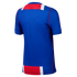 Back view of a blue athletic jersey featuring red and white horizontal bands across the top and bottom with red piping along the sides.
