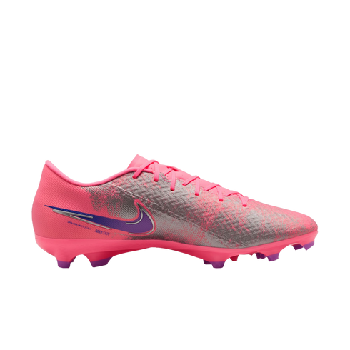 Side view of a bright pink Nike soccer cleat with metallic silver textures and a purple swoosh, set against a black background.