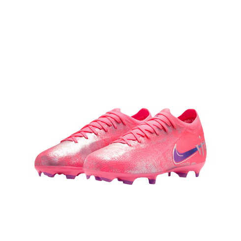 A pair of iridescent pink Nike soccer cleats with purple accents, set against a solid black background.