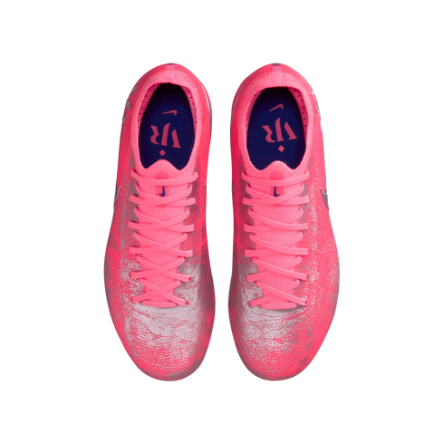 Top-down view of bright pink and silver Nike soccer cleats with matching pink laces and dark blue interiors, isolated on a black background.