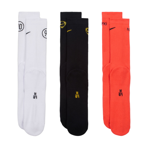 Three pairs of Nike T90 crew socks in white, black, and red, featuring small logos and size markings, arranged vertically on a black background.