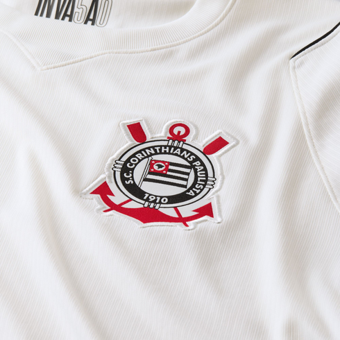 Close-up of a white jersey featuring the embroidered crest of the S.C. Corinthians Paulista football club.