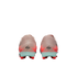 Rear view of pink and orange Nike soccer cleats with light blue heel counters and red studs against a black background.