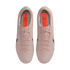 Top-down view of light pink Nike Mercurial soccer cleats with black swooshes and orange insoles, set against a black background.
