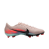 Side view of a light pink Nike soccer cleat with a black swoosh, red and blue heel graphics, and ".002 x L. JAMES + S. PARALLUELO" text.