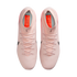 Top-down view of light pink Nike soccer cleats with matching laces and orange insoles on a black background.