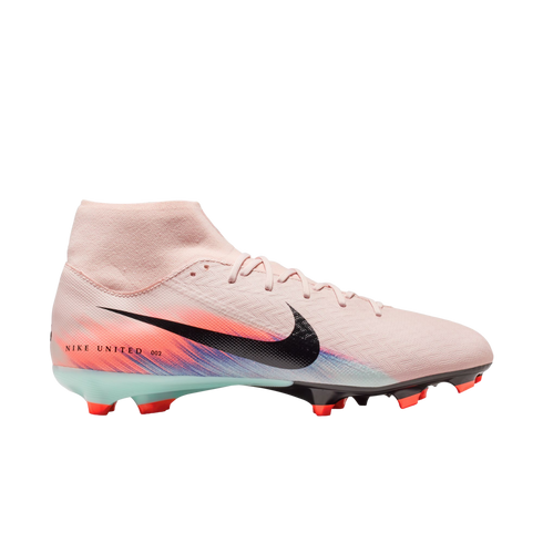 Side view of a light pink Nike soccer cleat with a black Swoosh, colorful heel graphic, and high-top collar on a black background.