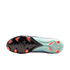 The sole of a Nike soccer cleat with a black forefoot, light teal heel, and bright orange studs.