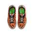 Top-down view of orange Nike sneakers with a black pixelated LEGO pattern, silver accents, and green insoles, featuring both Nike and LEGO branding.