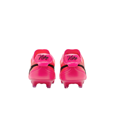 Back view of two bright pink Nike soccer cleats against a white background. Each heel features a cursive Nike logo in black above pink studs on the sole.