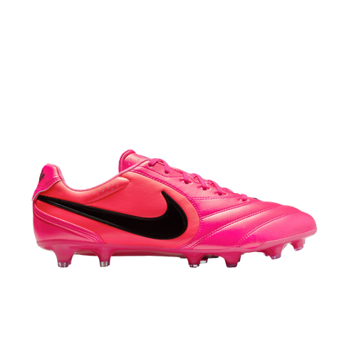 Side view of a vibrant pink Nike soccer cleat with a black swoosh logo on a white background.