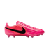 A side-profile view of a bright pink Nike soccer cleat with a large black swoosh on the side, pink laces, and pink studs.