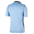 Rear view of a light blue short-sleeved sports jersey with dark trim at the collar and sides, displayed against a plain black background.