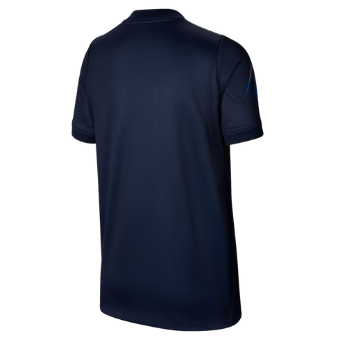 The back view of a dark blue short-sleeved athletic shirt with a subtle vertical ribbed texture, set against a solid black background.