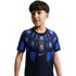 A young boy wearing a navy blue Uruguay national team soccer jersey with iridescent blue and purple patterns. The jersey features the AUF crest on the chest and a Nike swoosh logo, set against a solid black background.