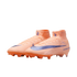 Peach-colored high-top Nike soccer cleats with a purple swoosh and orange studs, set against a black background.