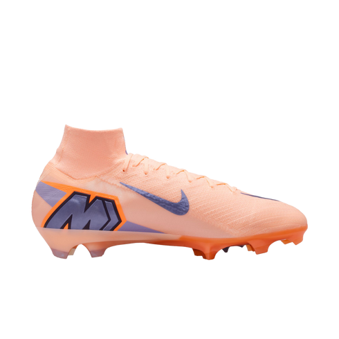 Side profile of a peach-colored Nike Mercurial soccer cleat with purple and orange accents against a black background.