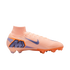 Side profile of a peach-colored Nike Mercurial soccer cleat with purple and orange accents against a black background.