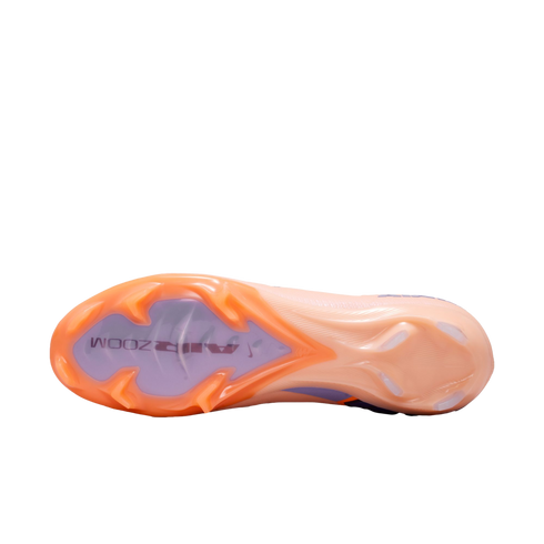 Underside of an orange and lavender Nike Air Zoom soccer cleat, displaying its unique stud pattern and "AIR ZOOM" branding against a black background.