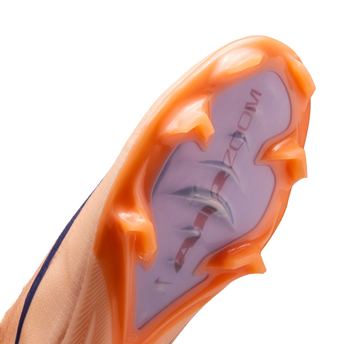 Close-up of a Nike soccer cleat's orange and purple sole plate with "AIR ZOOM" text and translucent studs.