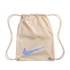 Cream-colored Nike drawstring bag with a repeating multilingual pattern of "Nike" and "soccer." A large light blue Nike swoosh is centered on the front.