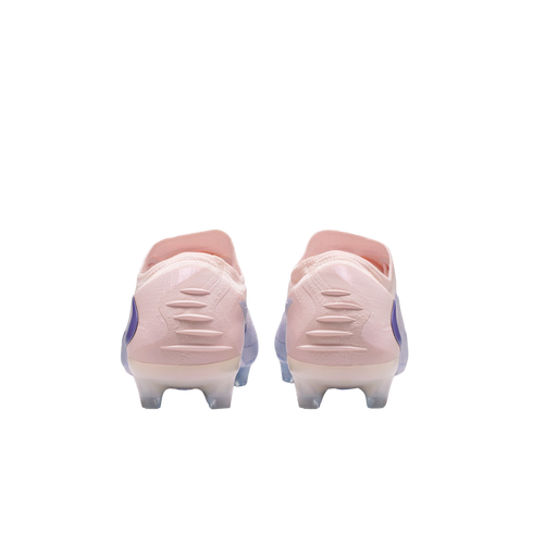 Rear view of two light pink Nike soccer cleats with blue accents and textured heel patterns on a black background.