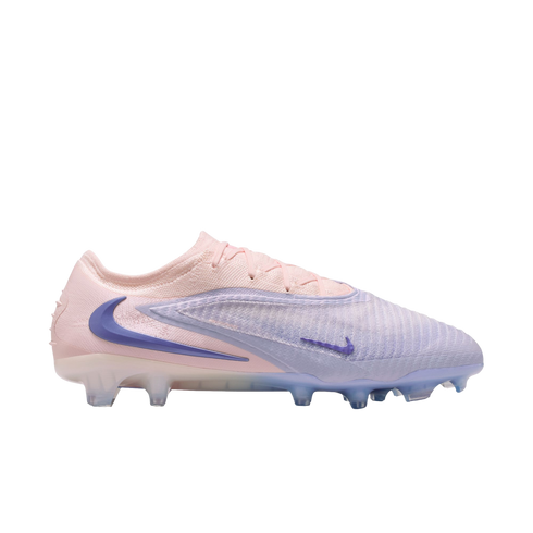 Side profile of a Nike Phantom GX soccer cleat in light pink and lavender with dark blue swooshes, displayed against a black background.