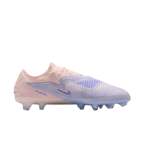 Side profile of a Nike Phantom soccer cleat with a pink and lavender colorway, featuring clear studs against a black background.