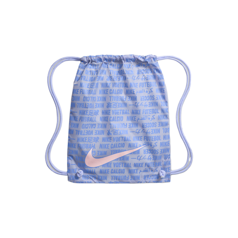 Light purple Nike drawstring bag with a large pink swoosh over a pattern of 'NIKE' and 'soccer' in multiple languages. Set against a black background.